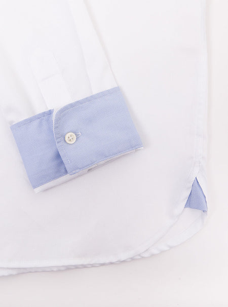 Flat lay of men's white long sleeved shirt with a button down collar with sky blue trimmings inside collar and cuffs made with 100% Royal Oxford Cotton.